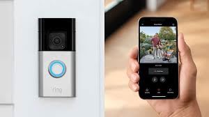 A hand holding a smartphone displaying a video feed from a ring security camera.